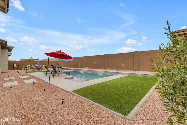 view of swimming pool with a patio and a lawn