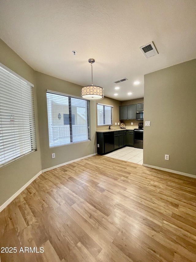 19400 N Westbrook Pkwy Unit 216, Peoria, AZ 85382 - unfurnished living room featuring baseboards, light wood-style floors, and visible vents