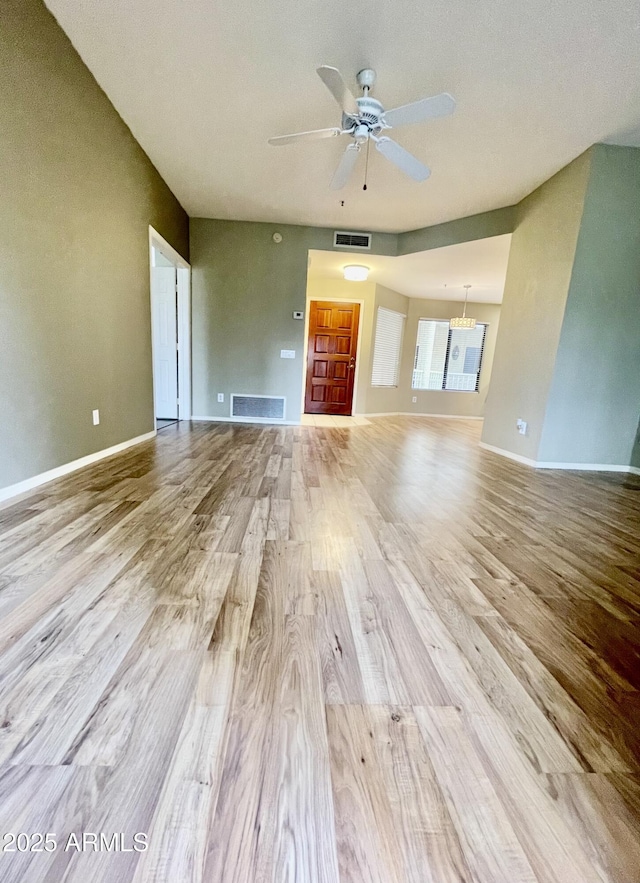 19400 N Westbrook Pkwy Unit 216, Peoria, AZ 85382 - unfurnished living room featuring a ceiling fan, baseboards, visible vents, and wood finished floors