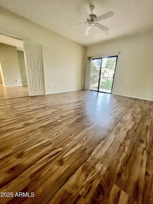 19400 N Westbrook Pkwy Unit 216, Peoria, AZ 85382 - spare room featuring baseboards, wood finished floors, and a ceiling fan