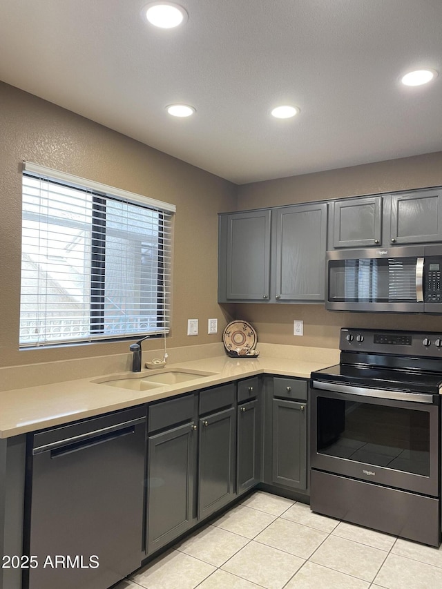 19400 N Westbrook Pkwy Unit 216, Peoria, AZ 85382 - kitchen featuring recessed lighting, light tile patterned flooring, a sink, light countertops, and appliances with stainless steel finishes