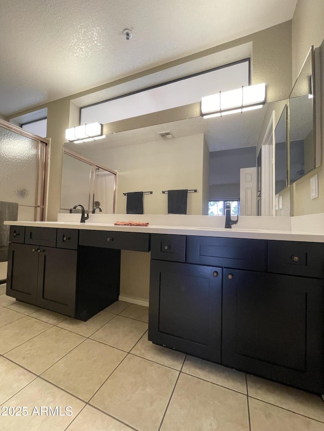 19400 N Westbrook Pkwy Unit 216, Peoria, AZ 85382 - full bath with a shower stall, tile patterned flooring, vanity, and visible vents