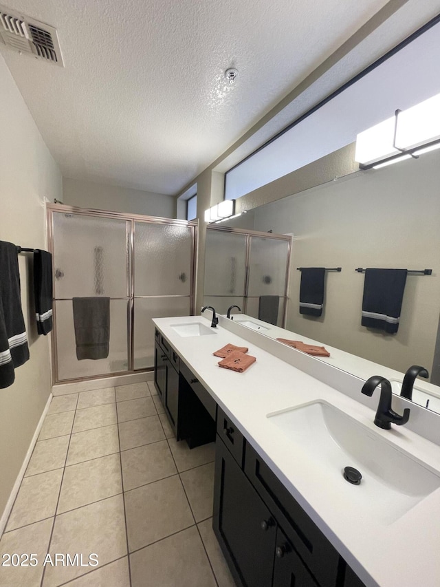 19400 N Westbrook Pkwy Unit 216, Peoria, AZ 85382 - bathroom featuring a textured ceiling, visible vents, a stall shower, and a sink