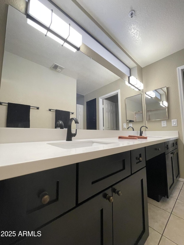 19400 N Westbrook Pkwy Unit 216, Peoria, AZ 85382 - bathroom with a sink, tile patterned flooring, double vanity, and visible vents