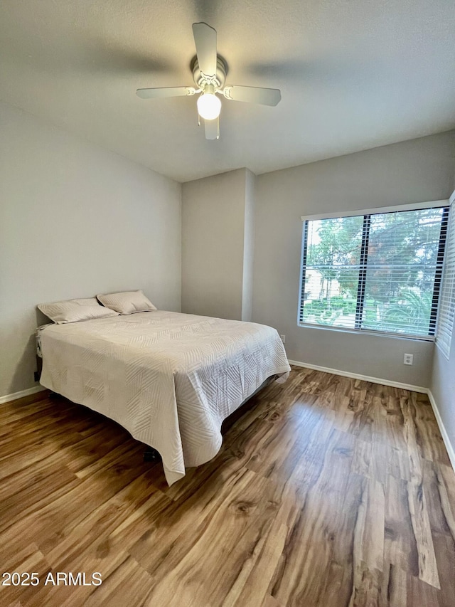 19400 N Westbrook Pkwy Unit 216, Peoria, AZ 85382 - bedroom with wood finished floors, baseboards, and ceiling fan