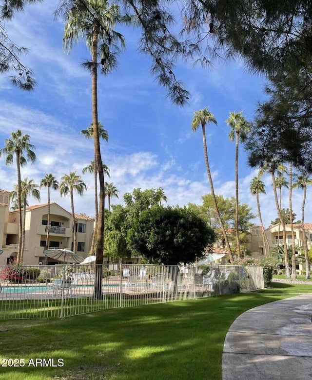 19400 N Westbrook Pkwy Unit 216, Peoria, AZ 85382 - view of community featuring a lawn, a swimming pool, and fence