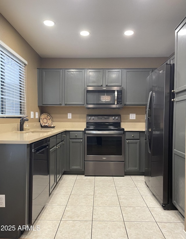19400 N Westbrook Pkwy Unit 216, Peoria, AZ 85382 - kitchen featuring recessed lighting, light tile patterned floors, a sink, black appliances, and light countertops