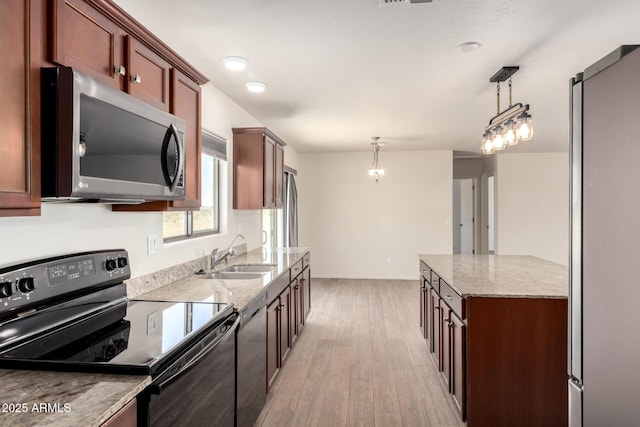 31515 W Buchanan St, Buckeye, AZ 85326 - kitchen featuring black / electric stove, stainless steel microwave, light wood-style floors, decorative light fixtures, and dishwashing machine
