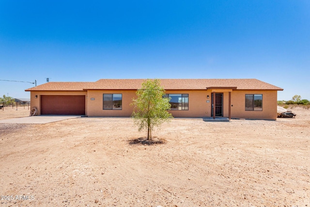 31515 W Buchanan St, Buckeye, AZ 85326 - view of front facade featuring a garage, driveway, and stucco siding