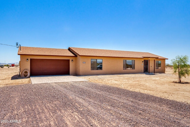 31515 W Buchanan St, Buckeye, AZ 85326 - ranch-style house featuring driveway, a garage, and stucco siding