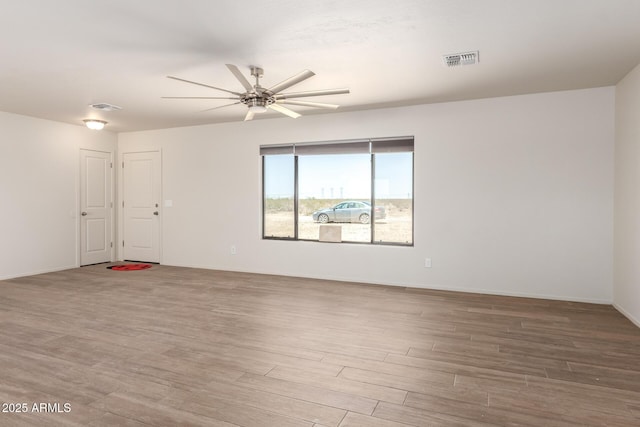 31515 W Buchanan St, Buckeye, AZ 85326 - empty room with wood finished floors and a ceiling fan
