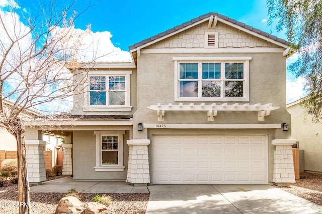 view of front of property featuring concrete driveway, a garage, and stucco siding