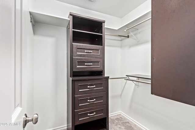 spacious closet featuring visible vents and carpet floors