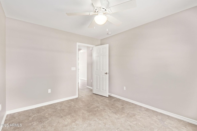 empty room with baseboards and ceiling fan