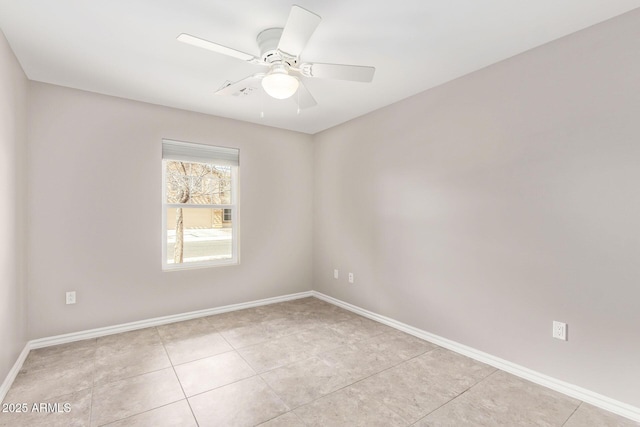 unfurnished room with light tile patterned floors, ceiling fan, and baseboards