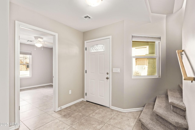 entrance foyer with light tile patterned flooring, ceiling fan, and baseboards