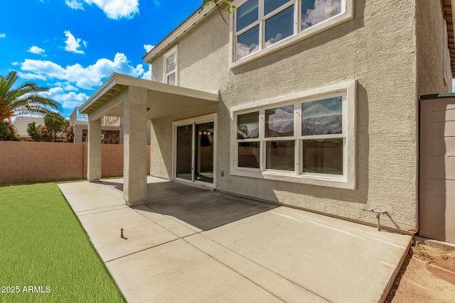 exterior space with a patio area, stucco siding, and fence