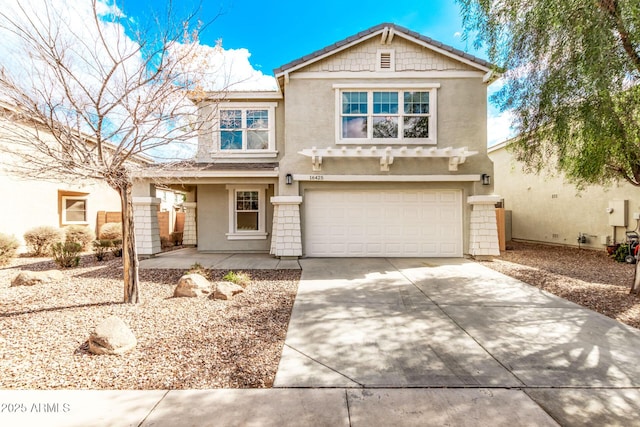 view of front of home featuring an attached garage, driveway, and stucco siding