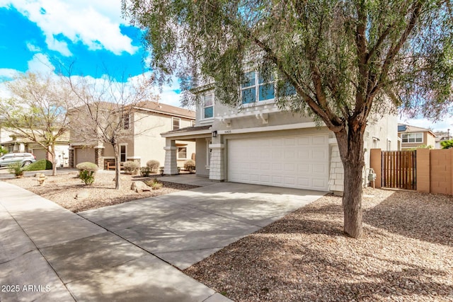 view of front of property featuring stucco siding, driveway, fence, a residential view, and a garage