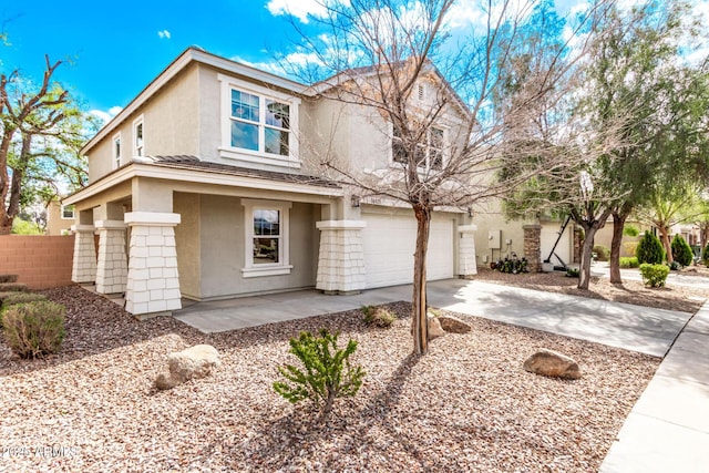 view of front of home featuring a garage, fence, concrete driveway, and stucco siding