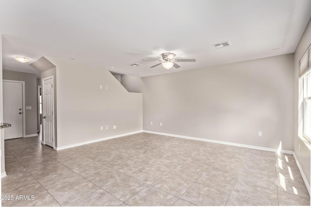 unfurnished room featuring light tile patterned floors, a ceiling fan, visible vents, and baseboards