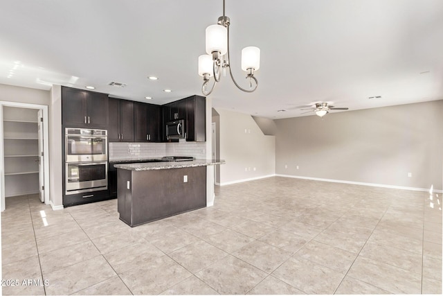 kitchen featuring light stone countertops, baseboards, stainless steel appliances, ceiling fan with notable chandelier, and tasteful backsplash