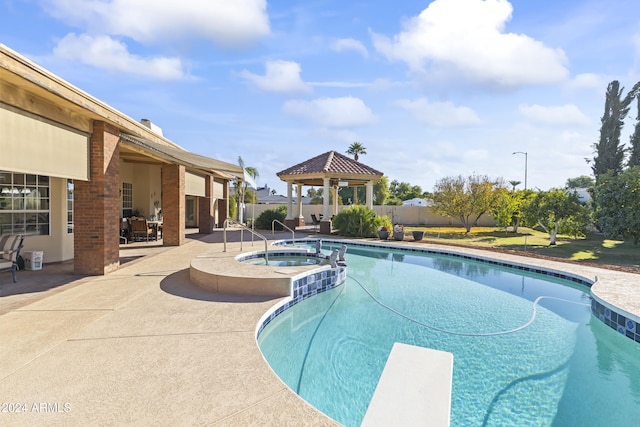 view of swimming pool featuring an in ground hot tub, a gazebo, a patio, and a diving board