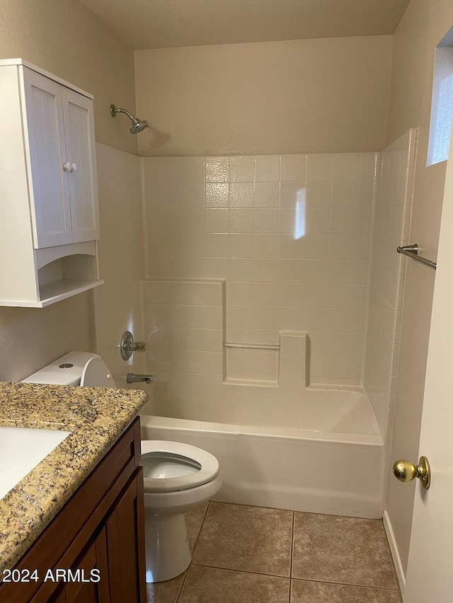 full bathroom featuring tub / shower combination, toilet, vanity, and tile patterned flooring