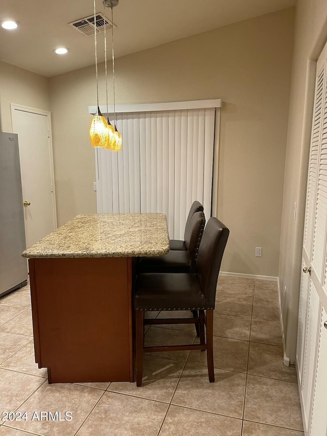 dining area with light tile patterned floors