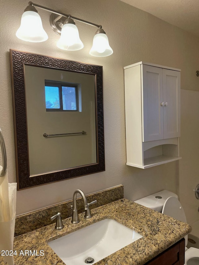 bathroom featuring toilet and vanity