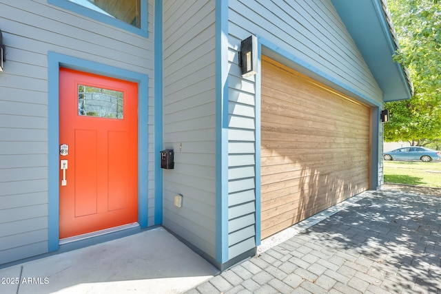 view of exterior entry with a garage