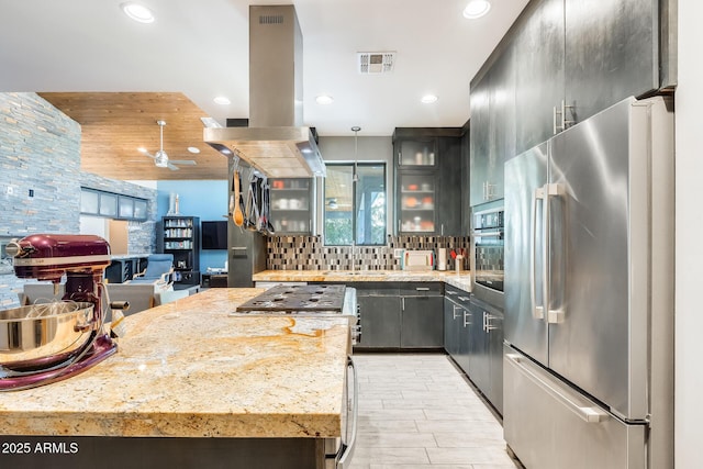 kitchen with visible vents, glass insert cabinets, recessed lighting, appliances with stainless steel finishes, and backsplash