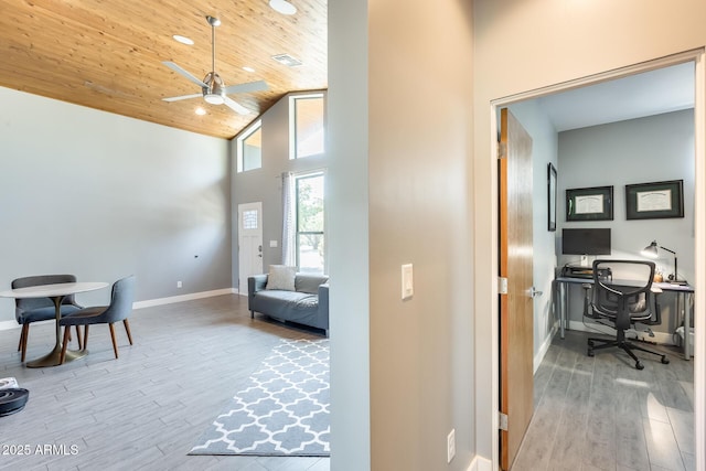 office space featuring ceiling fan, high vaulted ceiling, baseboards, wood finished floors, and wood ceiling