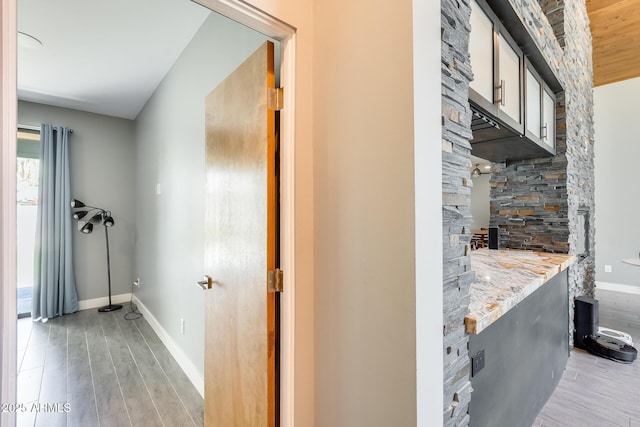hallway with baseboards and light wood-type flooring