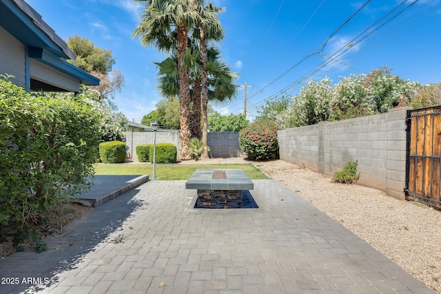view of patio / terrace with a fenced backyard and a fire pit