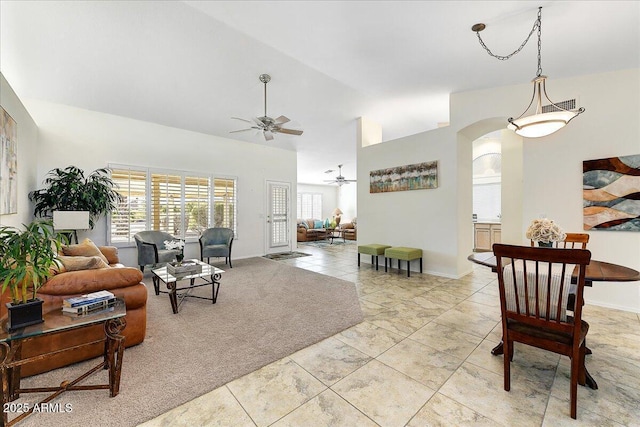 living room featuring ceiling fan, light tile patterned floors, and lofted ceiling