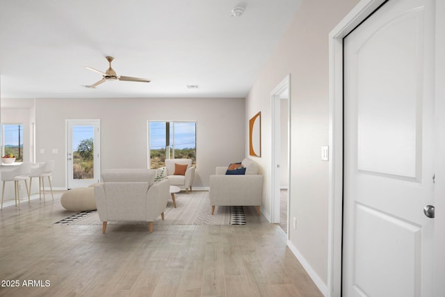 11203 E Crescent Ave, Mesa, AZ 85208 - living area featuring light wood-style flooring, baseboards, and ceiling fan