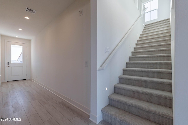 staircase with wood-type flooring