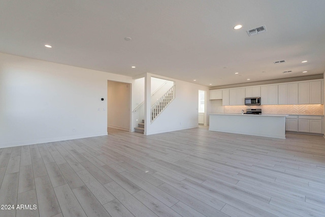 unfurnished living room with light wood-type flooring