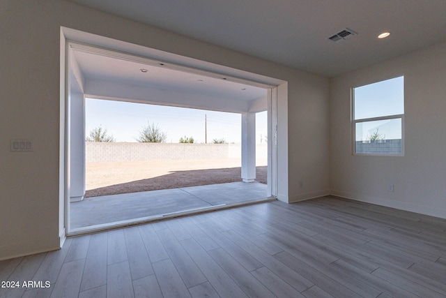 empty room featuring light hardwood / wood-style floors and a healthy amount of sunlight