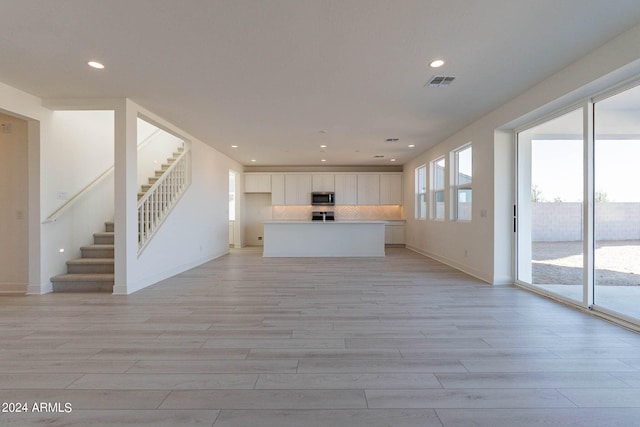 unfurnished living room featuring light hardwood / wood-style floors