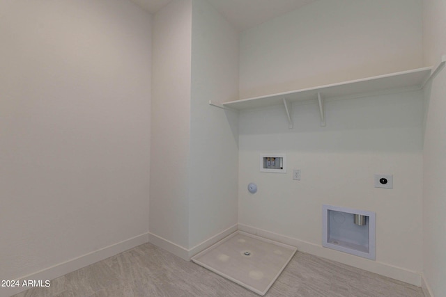 laundry room with carpet, electric dryer hookup, gas dryer hookup, and hookup for a washing machine