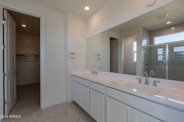 bathroom with vanity and walk in shower