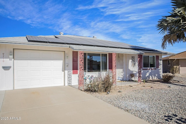 single story home featuring a garage and solar panels