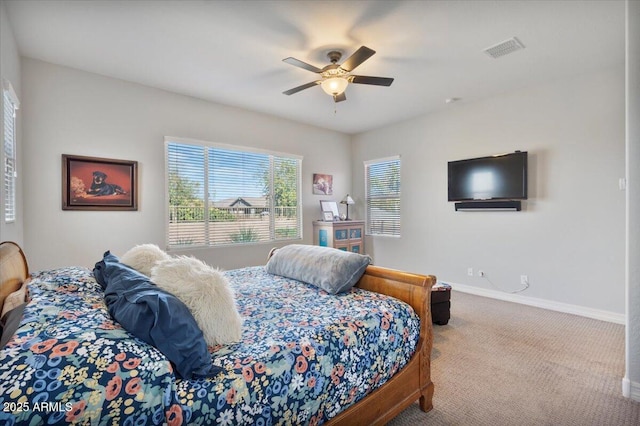 carpeted bedroom featuring a ceiling fan, baseboards, and visible vents