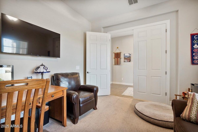 living room with visible vents, baseboards, and light colored carpet