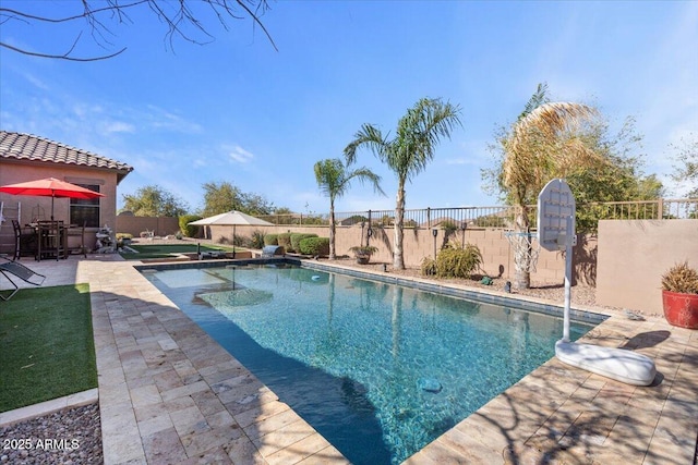 view of swimming pool featuring a fenced in pool, a patio, and a fenced backyard