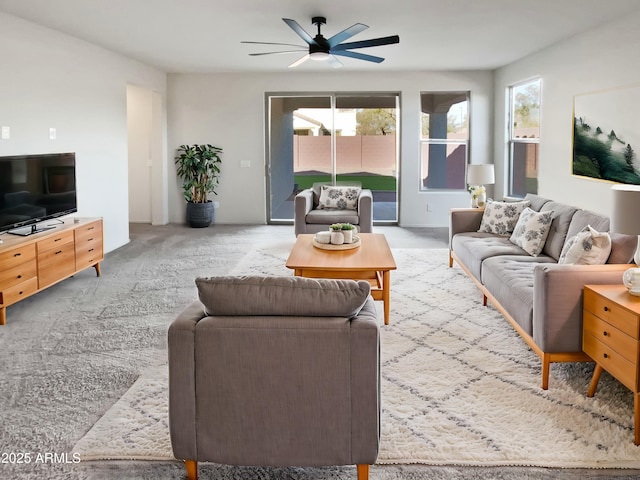 carpeted living room featuring ceiling fan