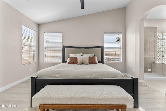 512 W Encinas St, Gilbert, AZ 85233 - bedroom with vaulted ceiling, arched walkways, light wood finished floors, and multiple windows