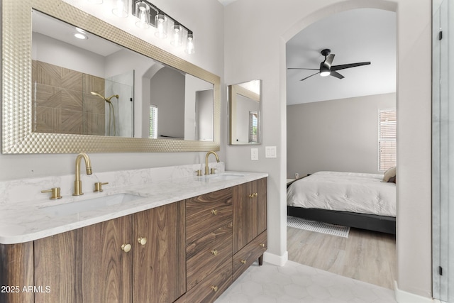 512 W Encinas St, Gilbert, AZ 85233 - ensuite bathroom with ceiling fan, double vanity, tiled shower, and tile patterned flooring